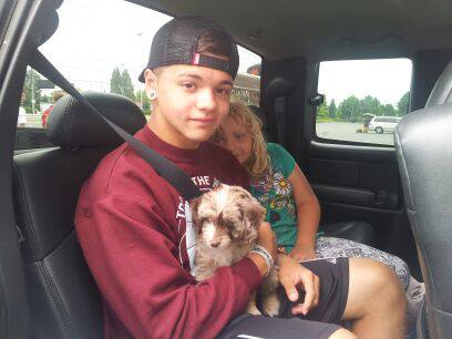 My Son and Daughter on the way to the airport with a Mini Aussiedoodle Puppy! 